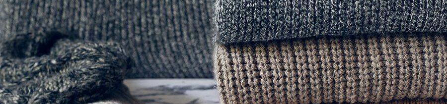 stack-cozy-knitted-sweaters-autumn-winter-concept-knitted-wool-sweaters-pile-knitted-winter-clothes-sweaters-knitwear_114579-1202